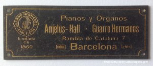 Placa comercial Pianos y Órganos "Angelus-Hall – Guarro Hermanos". Barcelona (Rambla de Cataluña, 7). Latón grabado y esmaltado. ca. 1903–1910.